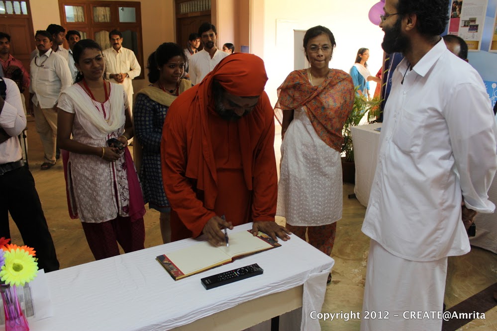 28-Sampoojya Swami Purnamritananda Puri signing the Vistors Register at the CREATE demo booth